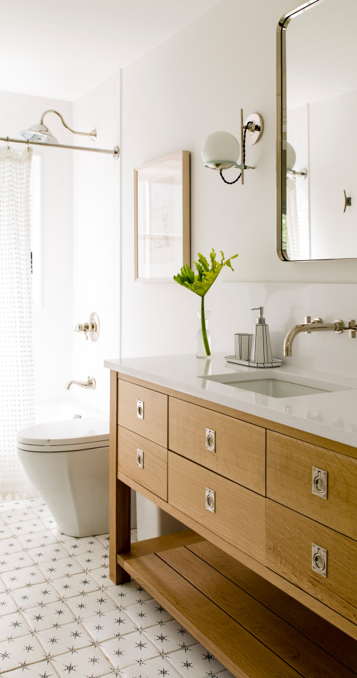 Inspiration for a beach style bathroom in DC Metro with flat-panel cabinets, medium wood cabinets, an alcove tub, a shower/bathtub combo, white tile, white walls, an undermount sink, white floor, a shower curtain, white benchtops and a freestanding vanity.