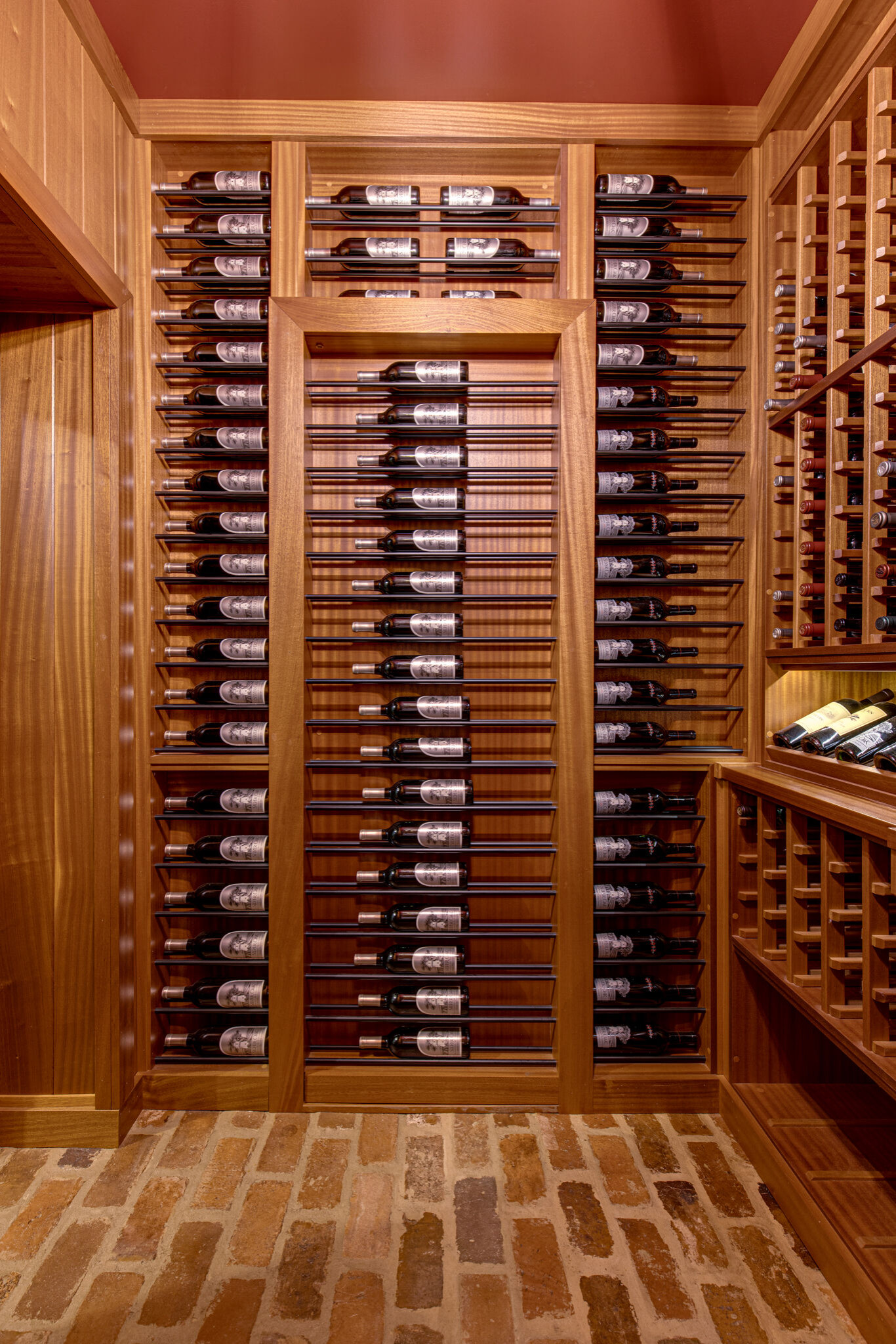 Secret passageway wine cellar. Basement layout with all mahogany racking.