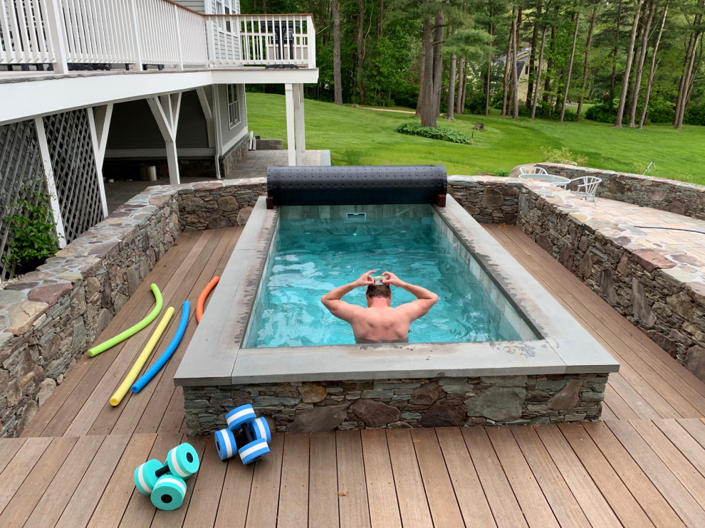Photo of a small eclectic backyard rectangular aboveground pool in Portland Maine with a hot tub and decking.