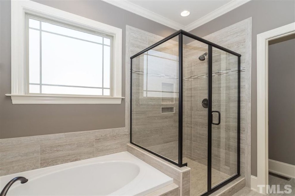 Photo of a large arts and crafts master bathroom in Raleigh with an undermount sink, flat-panel cabinets, dark wood cabinets, granite benchtops, an alcove shower, a one-piece toilet, gray tile, ceramic tile, grey walls, ceramic floors and a drop-in tub.
