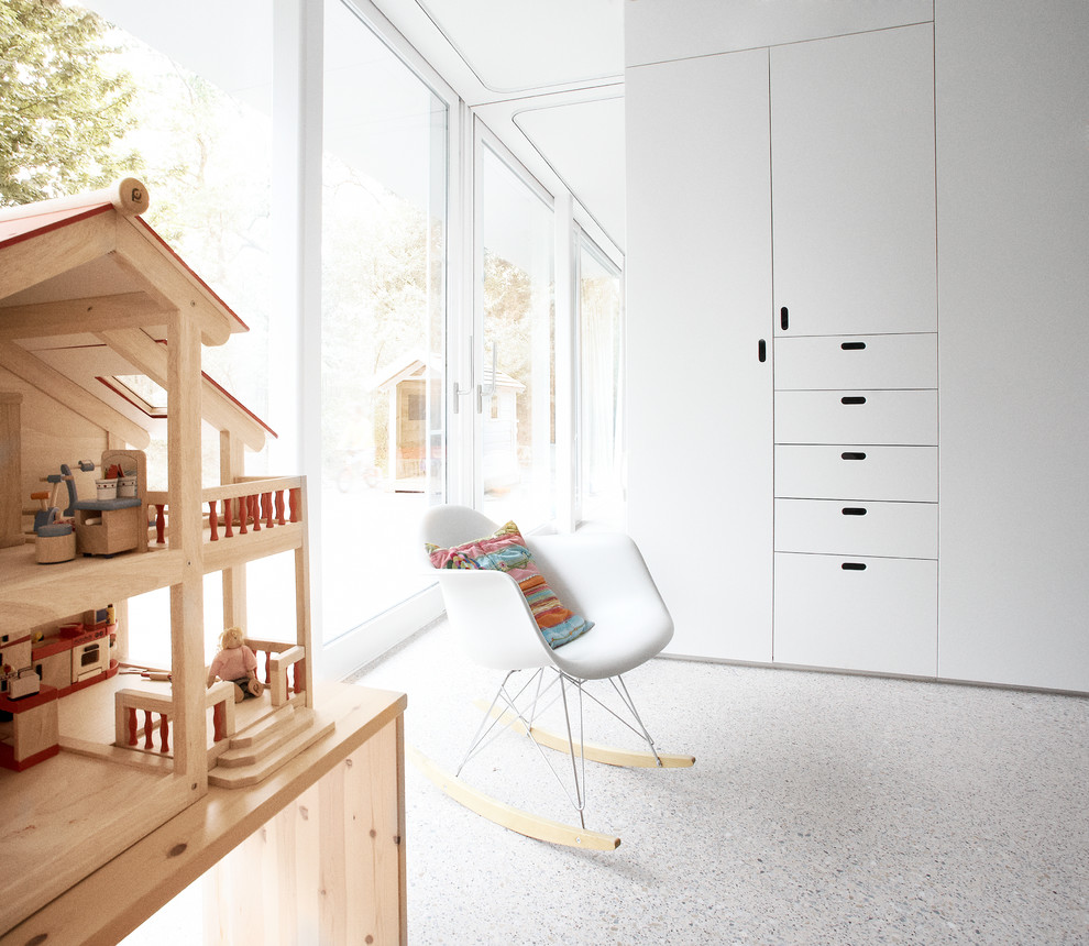 Modern kids' room in Other with concrete floors.