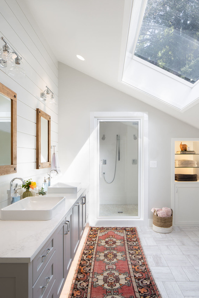 Design ideas for a large beach style master bathroom in Seattle with shaker cabinets, grey cabinets, a vessel sink, white benchtops, white walls, porcelain floors, marble benchtops, white floor and a hinged shower door.