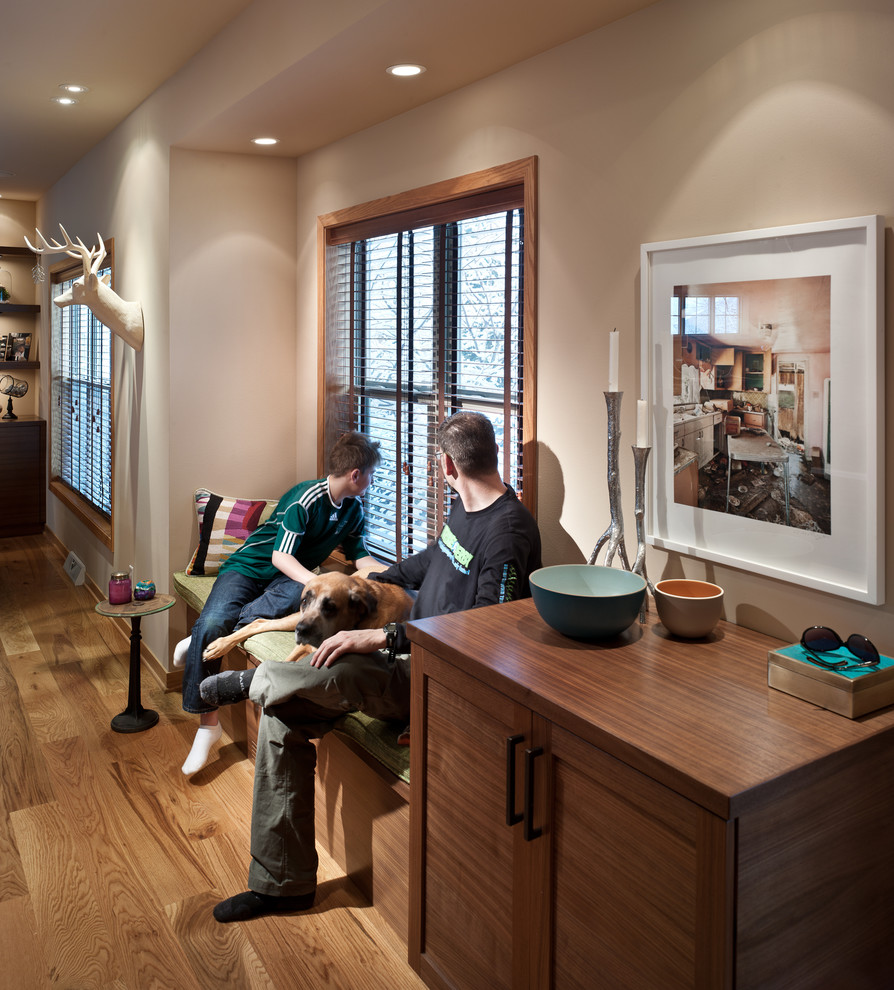 Mid-sized transitional medium tone wood floor open concept kitchen photo with an undermount sink, shaker cabinets, white cabinets, quartz countertops, green backsplash, glass tile backsplash, stainless steel appliances, beige walls and an island