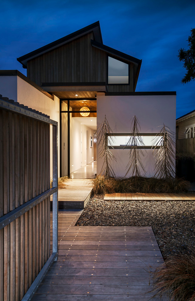 Photo of a small beach style exterior in Christchurch with wood siding.