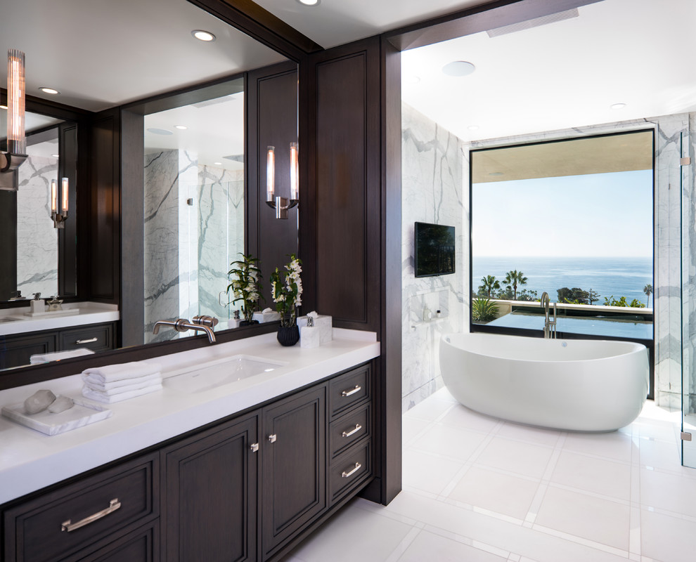 Design ideas for a large contemporary master bathroom in Phoenix with recessed-panel cabinets, dark wood cabinets, a freestanding tub, white tile, gray tile, an undermount sink, marble, brown walls, quartzite benchtops and white floor.