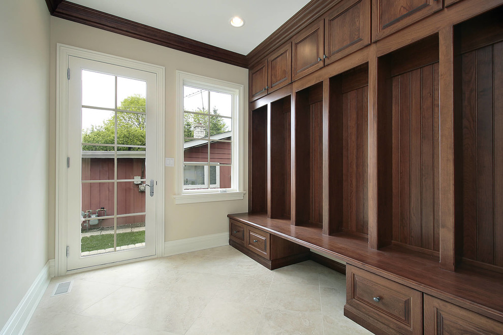 Photo of a mid-sized transitional mudroom in Cleveland with beige walls, a single front door, a glass front door, limestone floors and grey floor.