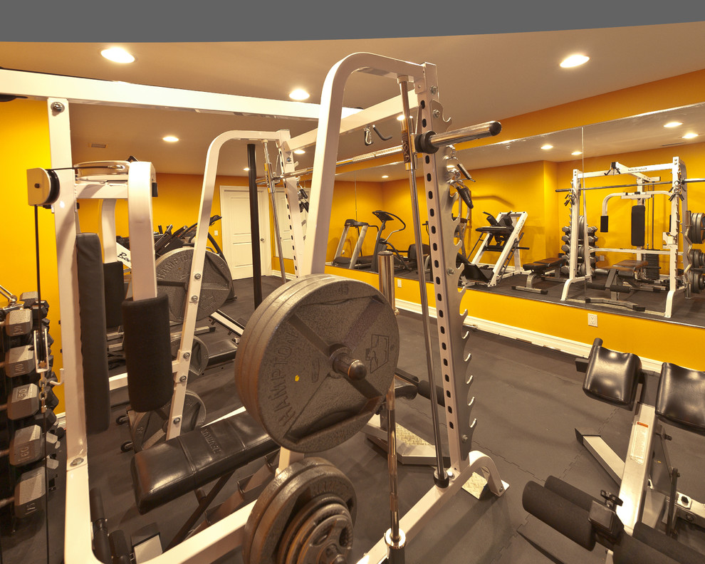 This is an example of a large contemporary home weight room in New York with yellow walls.