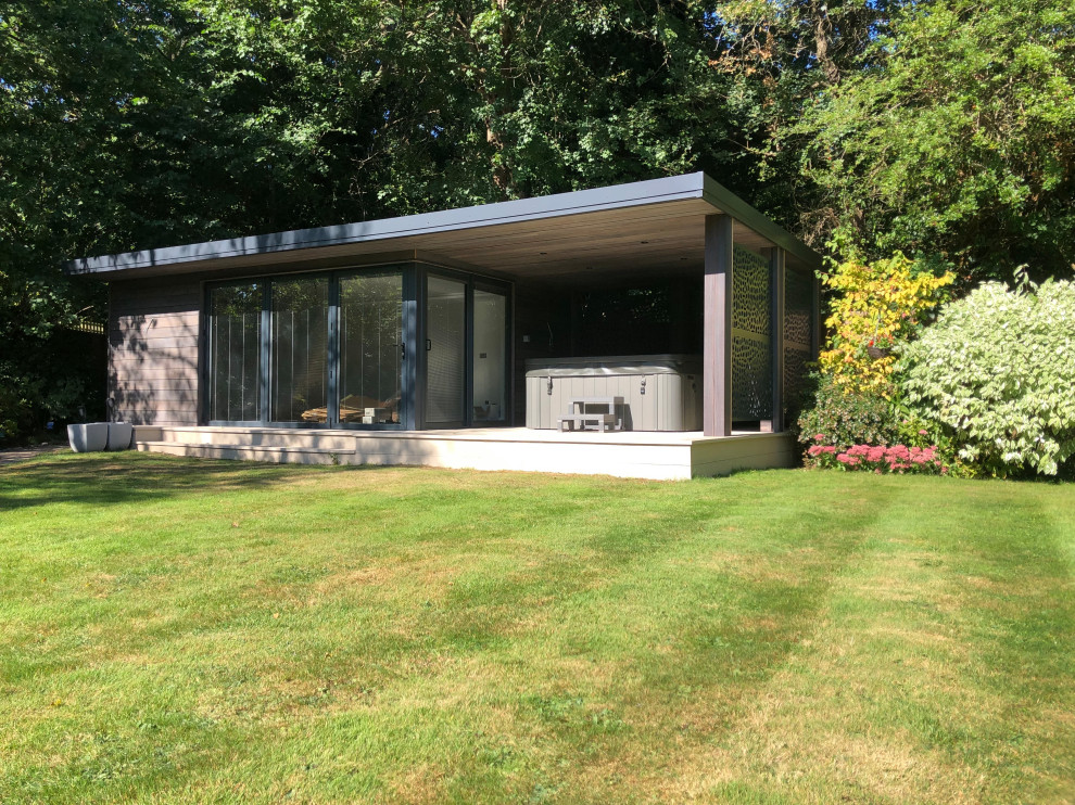 This is an example of a medium sized contemporary detached garden shed and building in Surrey.