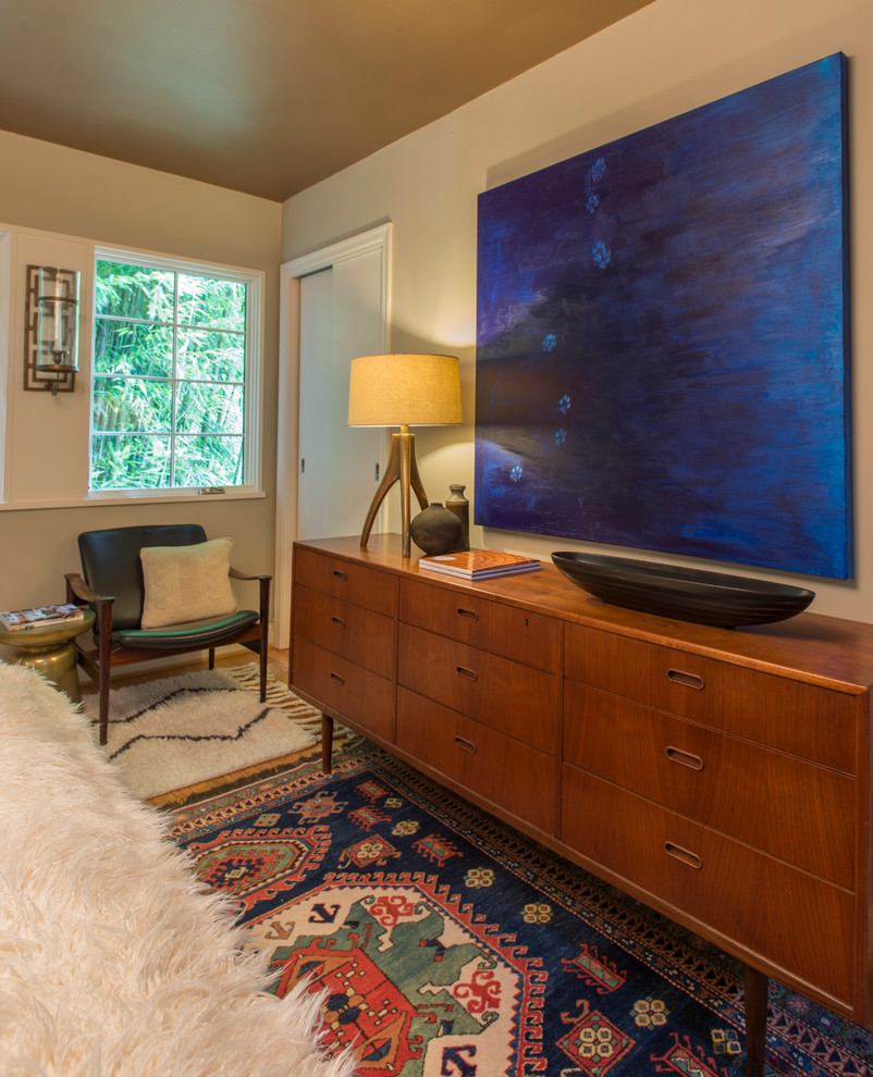 Example of a transitional master medium tone wood floor bedroom design in DC Metro with beige walls