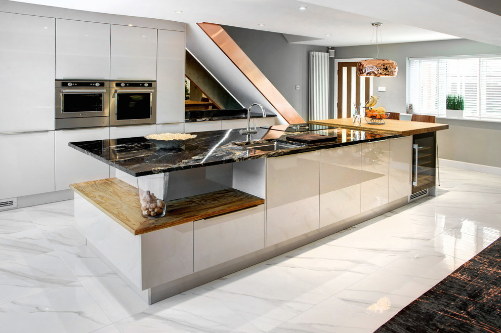 Inspiration for a mid-sized contemporary eat-in kitchen in Other with flat-panel cabinets, with island, white floor, white cabinets, granite benchtops, metallic splashback, mirror splashback, stainless steel appliances and porcelain floors.