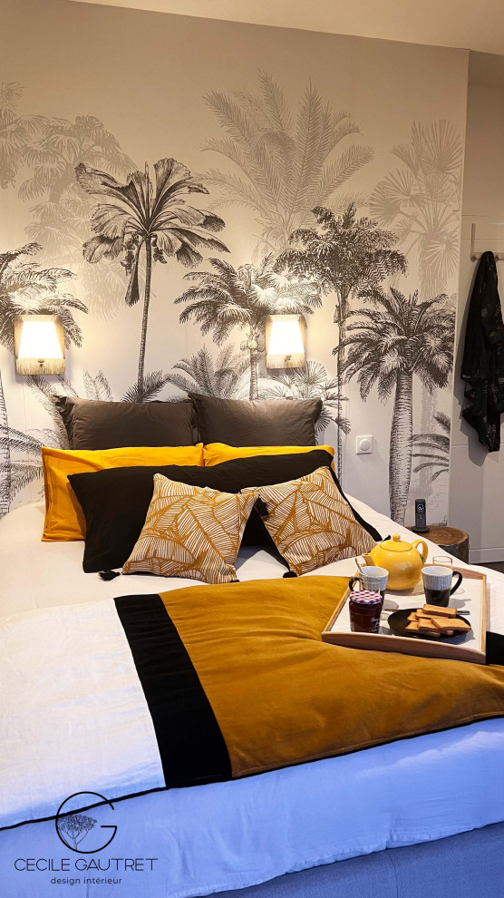 Photo of a tropical bedroom in Nantes with green walls, laminate floors, grey floor and wallpaper.