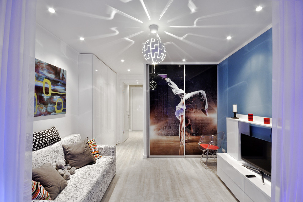Photo of a contemporary kids' room for girls in Other with light hardwood floors.