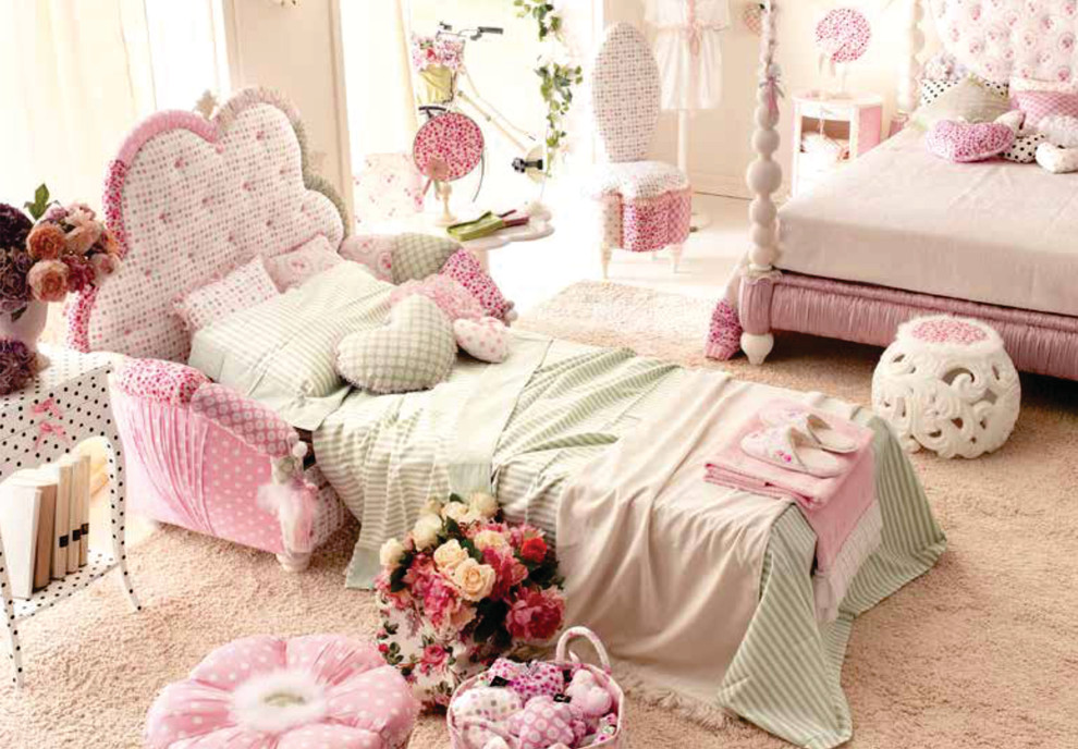 Inspiration for a large modern kids' room for girls in London with pink walls and carpet.