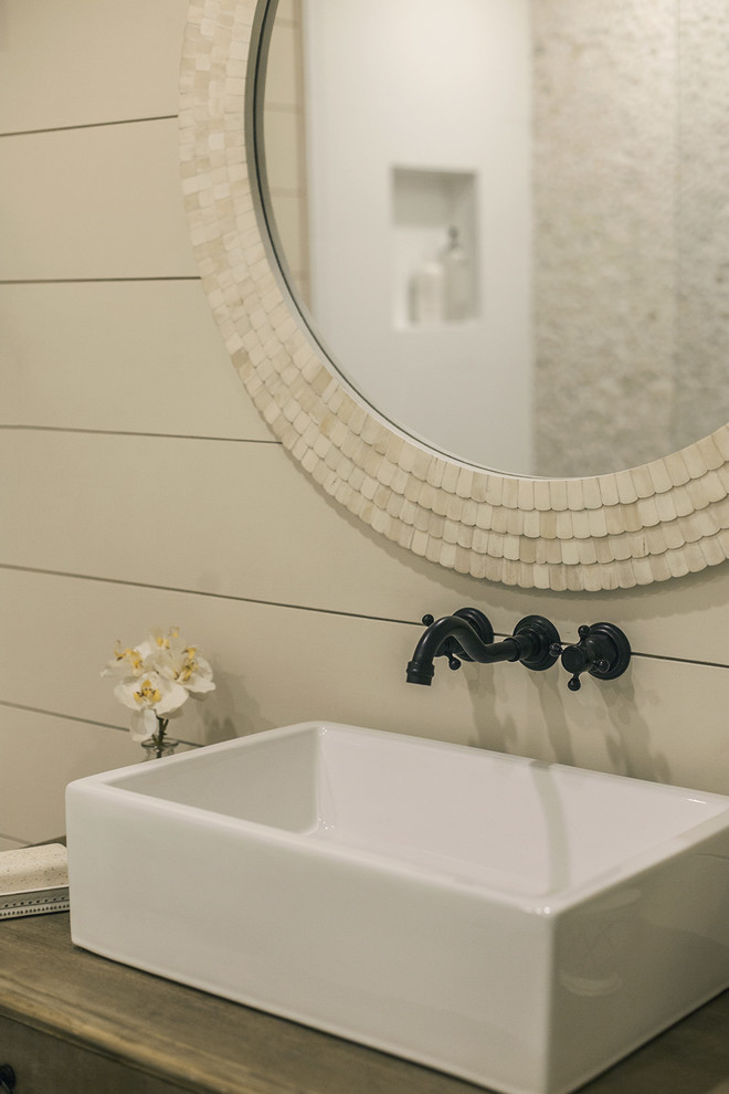 Mid-sized country master bathroom in Tampa with medium wood cabinets, a double shower, white tile, pebble tile, beige walls, pebble tile floors, a vessel sink, beige floor and an open shower.