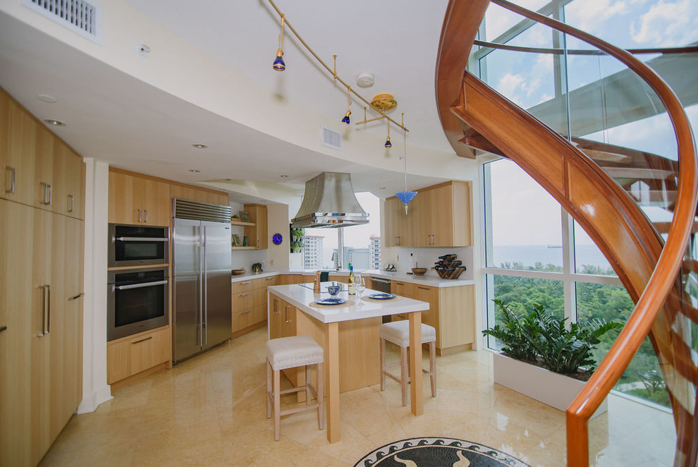 Inspiration for a mid-sized transitional u-shaped porcelain tile open concept kitchen remodel in Miami with an undermount sink, flat-panel cabinets, light wood cabinets, quartz countertops, white backsplash, stainless steel appliances, an island and white countertops