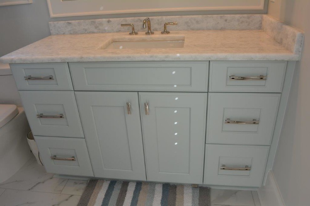 Photo of a large beach style 3/4 bathroom in Other with shaker cabinets, white cabinets, an alcove shower, white tile, marble, marble floors, an undermount sink, marble benchtops, white floor and a hinged shower door.