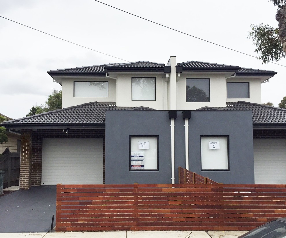 This is an example of a large contemporary two-storey concrete white exterior in Melbourne with a gable roof.