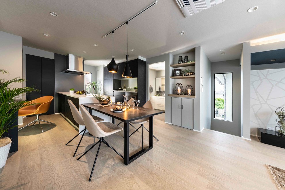 This is an example of a mid-sized modern single-wall separate kitchen in Other with an integrated sink, glass-front cabinets, black cabinets, recycled glass benchtops, brown splashback, panelled appliances, plywood floors, with island, grey floor and white benchtop.