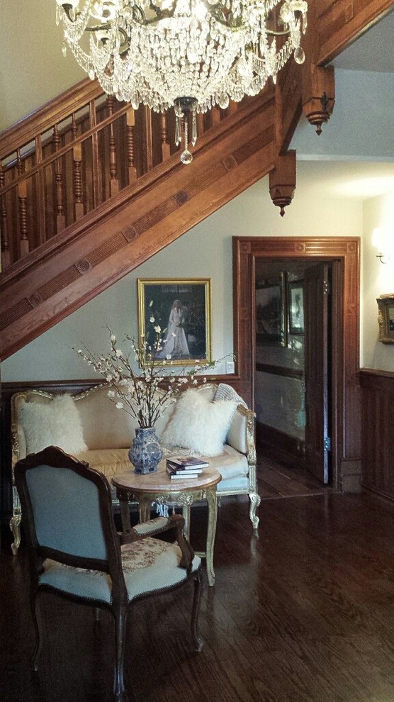 This is an example of a mid-sized traditional foyer in Other with grey walls, dark hardwood floors and brown floor.