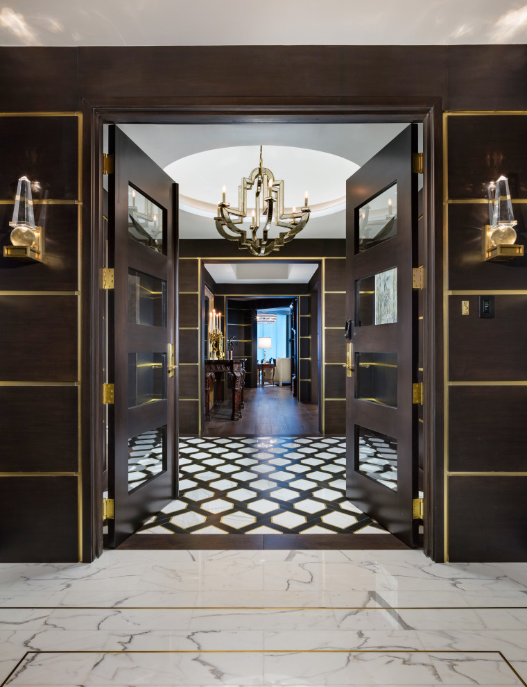 Inspiration for a large classic vestibule in Miami with brown walls, marble flooring, a double front door, a brown front door, white floors and panelled walls.