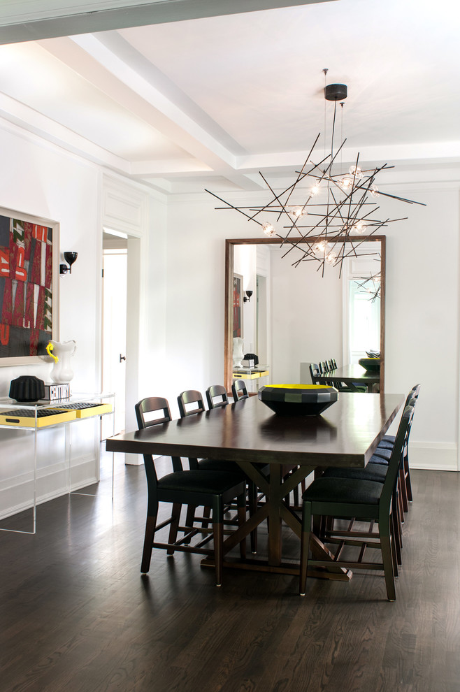 This is an example of a contemporary dining room in Toronto with white walls and dark hardwood floors.