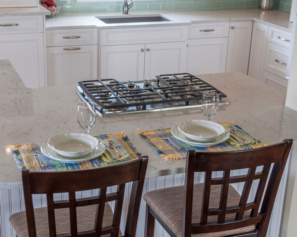 Inspiration for a mid-sized transitional medium tone wood floor eat-in kitchen remodel in Denver with a single-bowl sink, flat-panel cabinets, yellow cabinets, quartz countertops, blue backsplash, glass tile backsplash, white appliances and an island