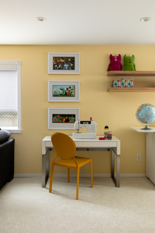 Photo of a large bohemian craft room in Seattle with yellow walls, carpet, white floors, all types of ceiling, all types of wall treatment, a freestanding desk and feature lighting.
