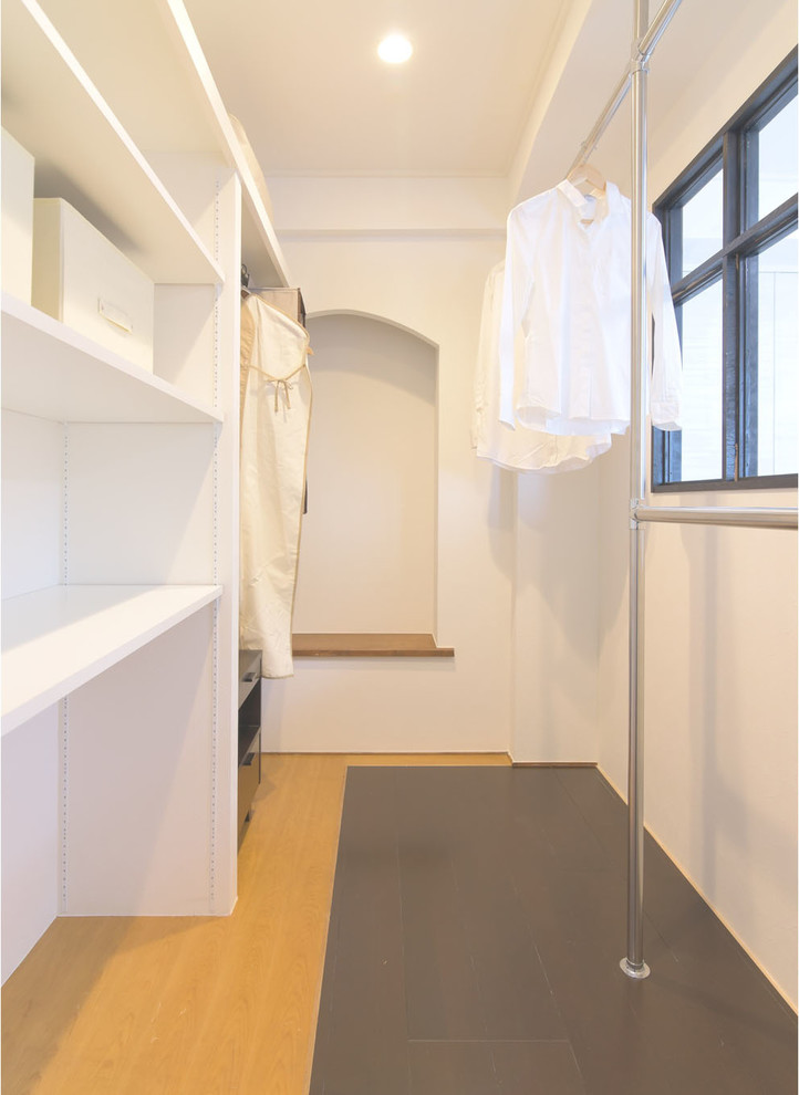 This is an example of an asian storage and wardrobe in Tokyo Suburbs with plywood floors.