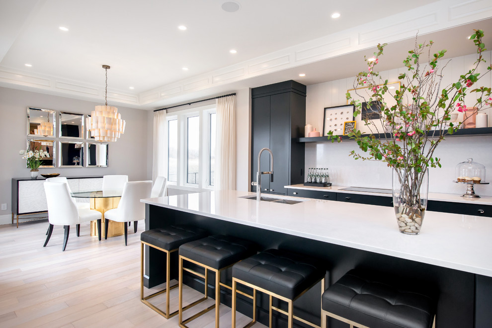 Large transitional l-shaped light wood floor eat-in kitchen photo in Calgary with an undermount sink, flat-panel cabinets, gray cabinets, quartz countertops, white backsplash, paneled appliances, an island and stone slab backsplash