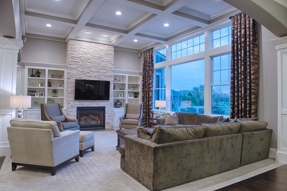 This is an example of a large transitional open concept family room in Indianapolis with grey walls, a standard fireplace, a stone fireplace surround, a wall-mounted tv, dark hardwood floors and brown floor.
