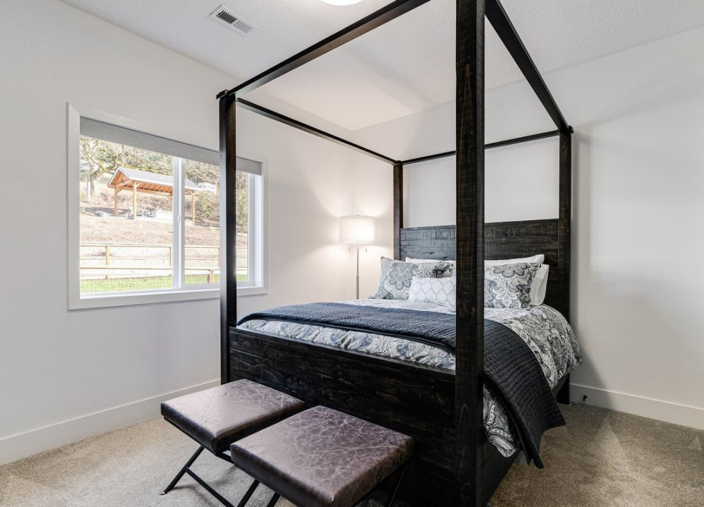 Medium sized rustic guest bedroom in Portland with white walls, carpet and beige floors.