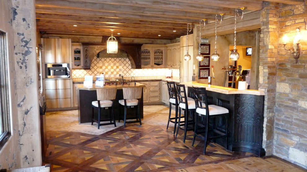 Inspiration for an eclectic kitchen remodel in Phoenix with beige backsplash, stone tile backsplash, stainless steel appliances and an island