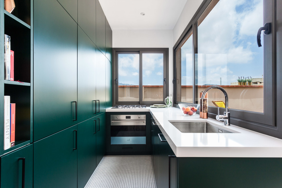 Contemporary kitchen in Barcelona with an undermount sink, flat-panel cabinets, green cabinets, window splashback, stainless steel appliances, no island, white floor and white benchtop.