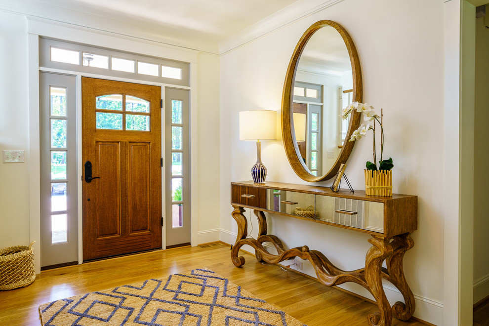 Example of a mid-sized transitional medium tone wood floor and brown floor front door design with white walls and a medium wood front door