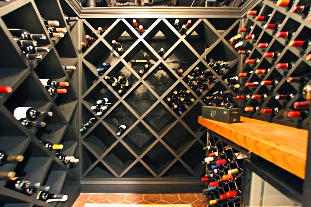 Small industrial wine cellar in New York with ceramic floors and diamond bins.