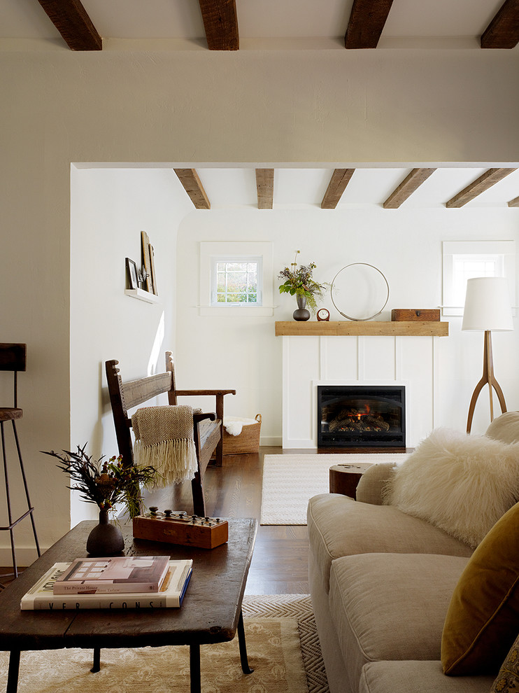 Country living room in San Francisco with white walls, a standard fireplace and no tv.
