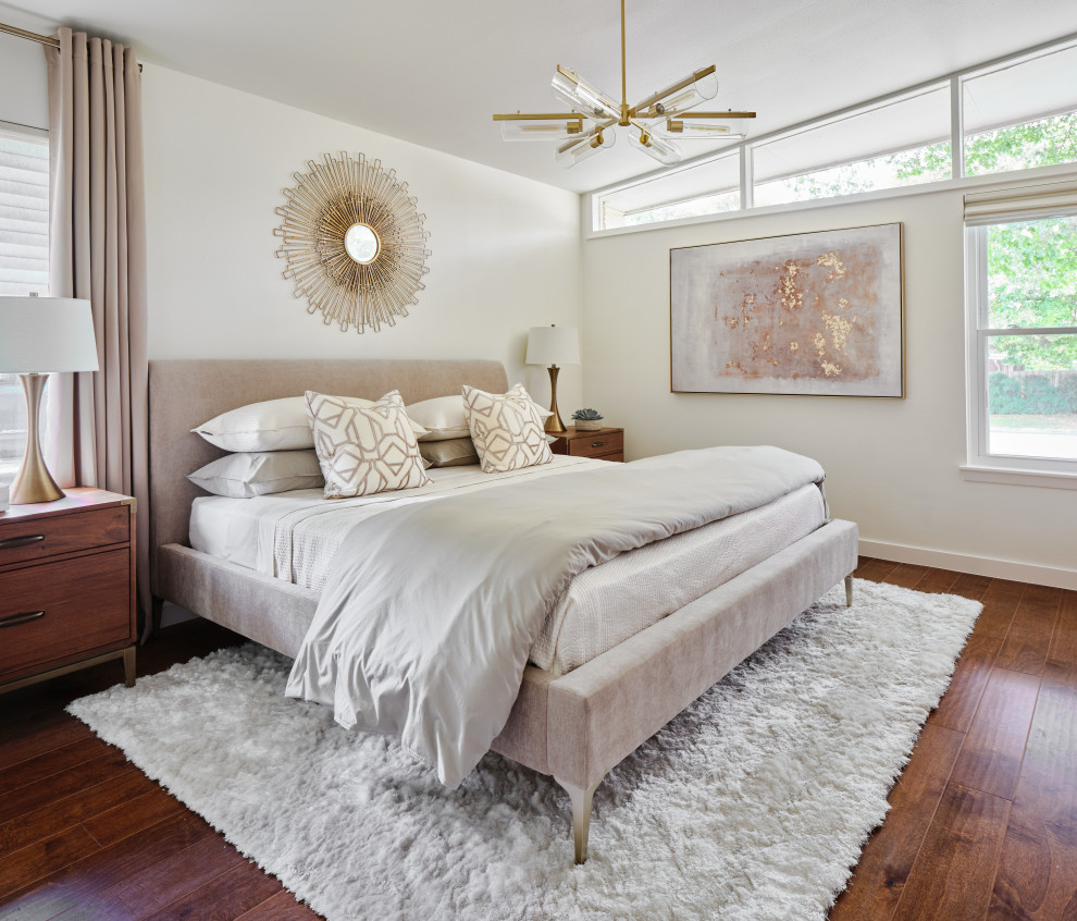 Inspiration for a mid-sized midcentury master bedroom in Austin with white walls, medium hardwood floors, brown floor and vaulted.