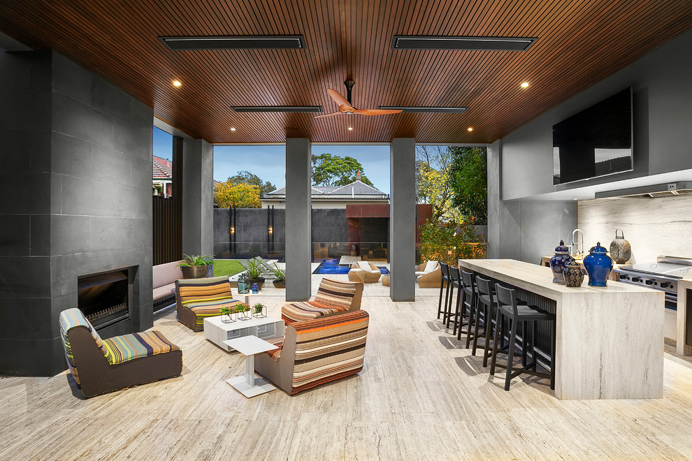 Photo of a contemporary patio in Melbourne with an outdoor kitchen and a roof extension.