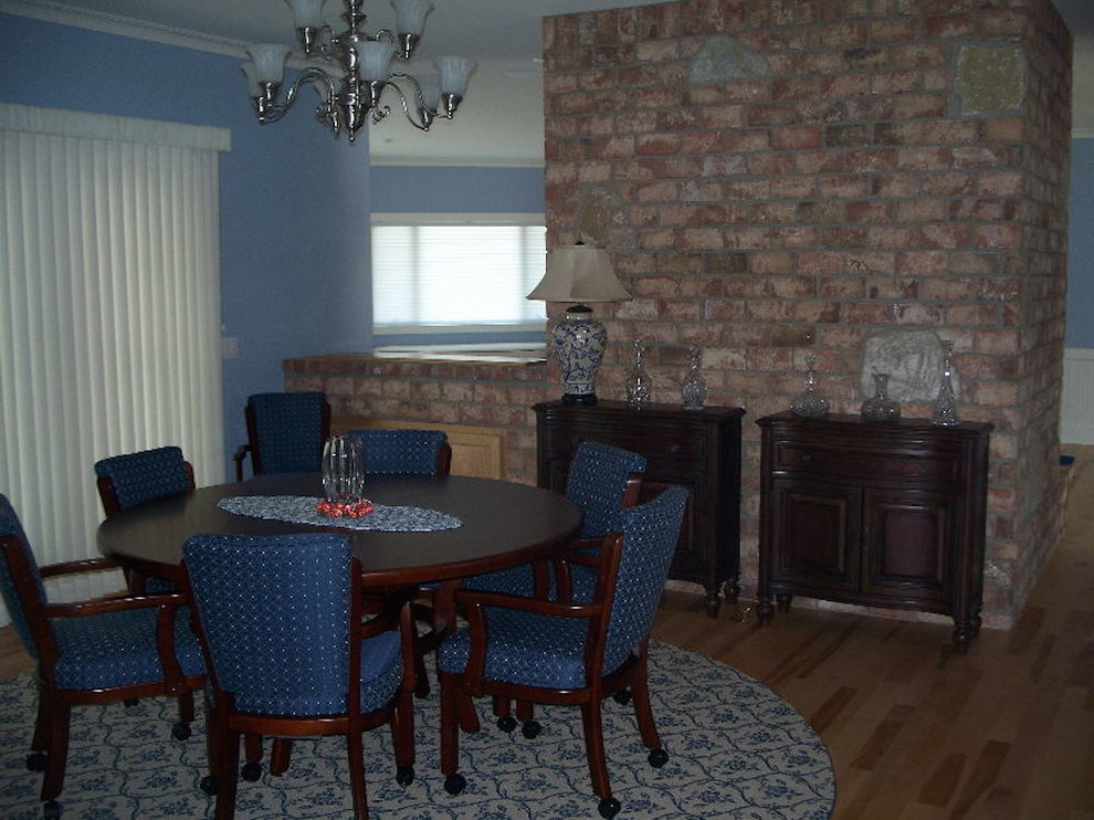 Example of a mid-sized transitional light wood floor dining room design in Milwaukee with blue walls
