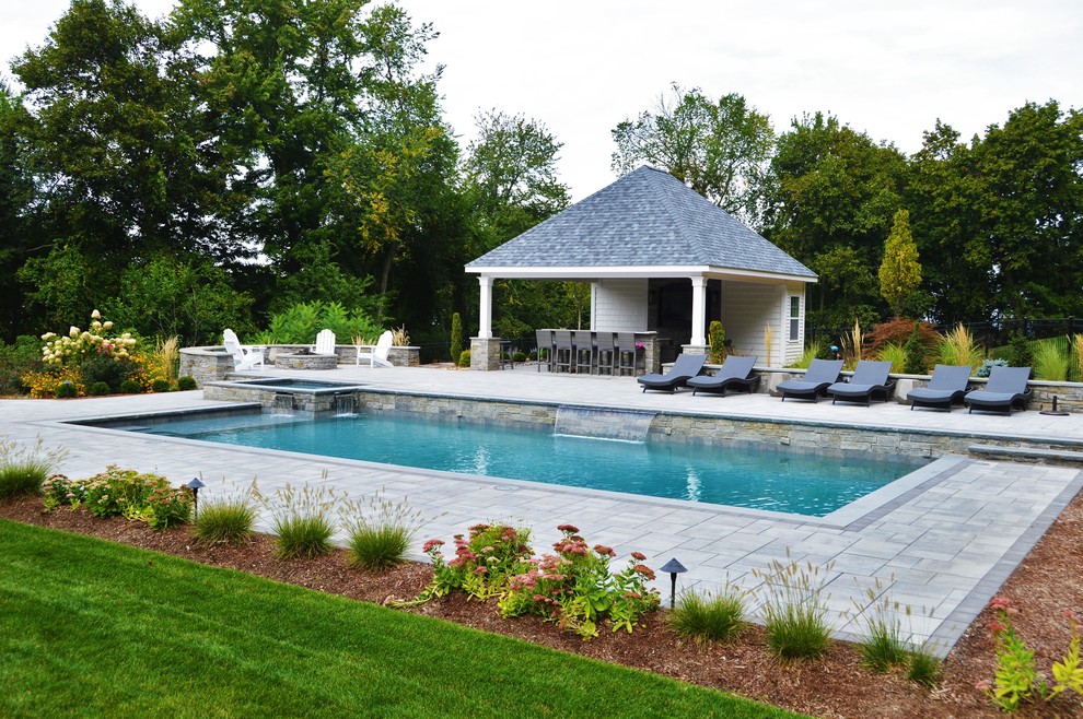 Large traditional backyard custom-shaped natural pool in Bridgeport with a hot tub and concrete pavers.