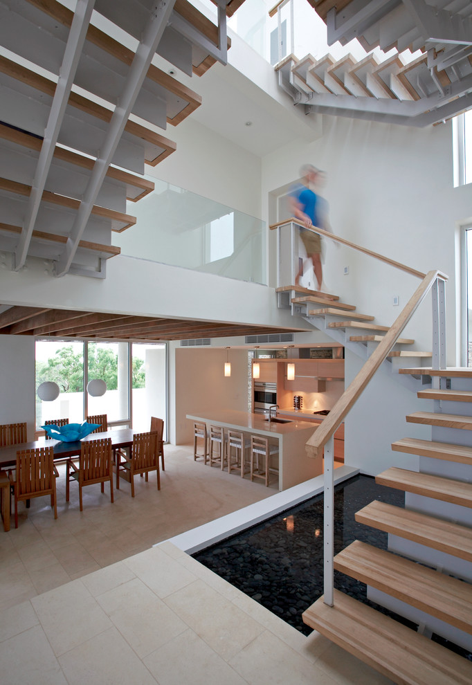 Photo of an expansive contemporary wood l-shaped staircase in Other with open risers.