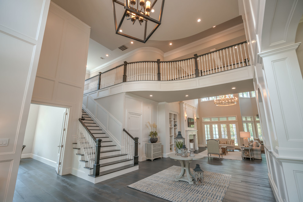 Large beach style foyer in Houston with white walls, dark hardwood floors, a single front door, a white front door, brown floor and wood walls.
