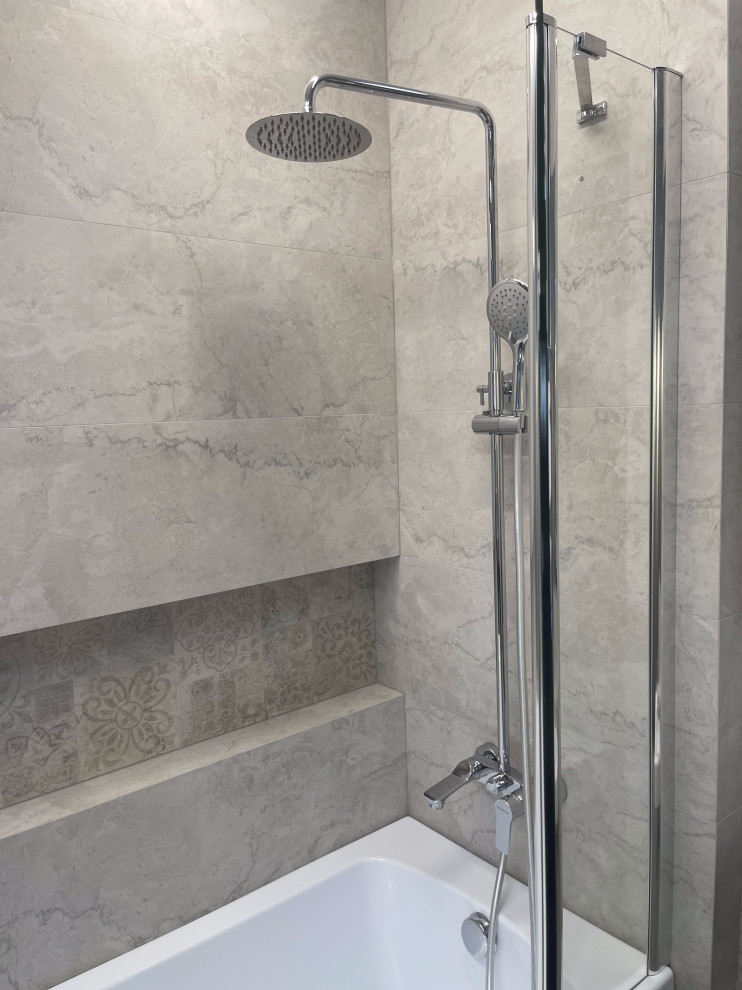 Mid-sized master bathroom in New York with a corner tub, a shower/bathtub combo, beige tile, ceramic tile, beige walls, tile benchtops, a hinged shower door and a niche.