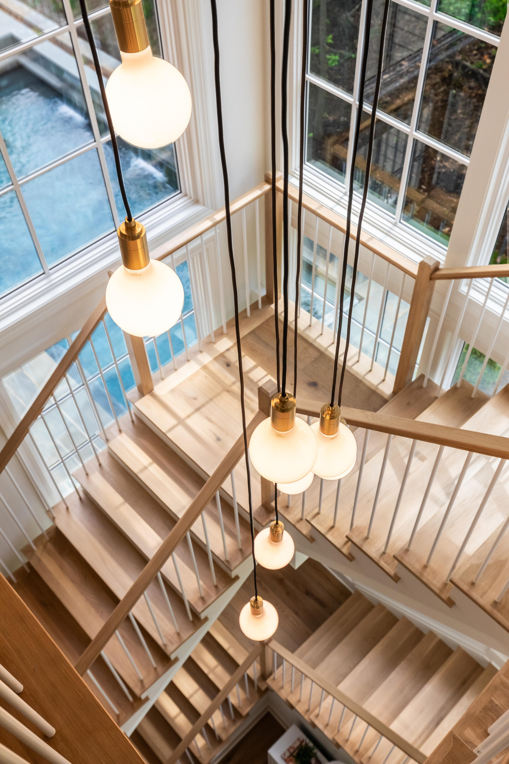 Project #152 | Three-Story White Oak Staircase with a Pendant Chandelier