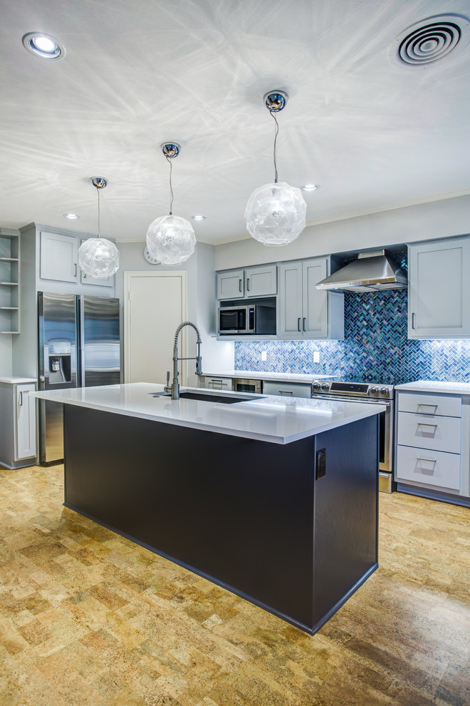 Large modern l-shaped eat-in kitchen in Dallas with an undermount sink, shaker cabinets, blue cabinets, quartz benchtops, blue splashback, mosaic tile splashback, stainless steel appliances, cork floors, with island, brown floor and white benchtop.