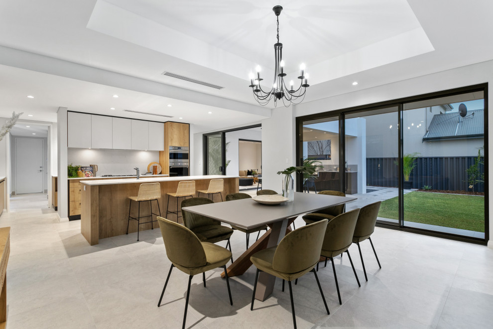 Photo of a contemporary kitchen/dining combo in Perth with white walls and grey floor.