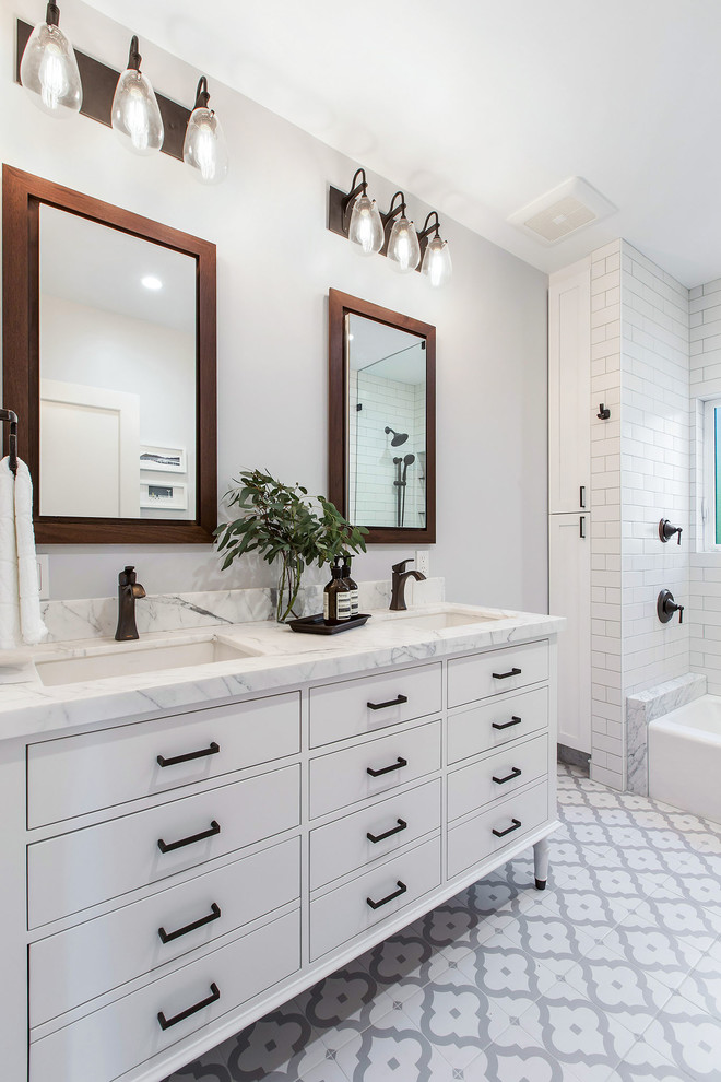 Inspiration for a mid-sized transitional bathroom in San Francisco with flat-panel cabinets, white cabinets, an alcove tub, a shower/bathtub combo, a wall-mount toilet, white tile, ceramic tile, grey walls, porcelain floors, an undermount sink, multi-coloured floor, an open shower and white benchtops.