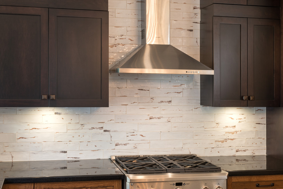 Large transitional slate floor and multicolored floor kitchen pantry photo in Vancouver with an undermount sink, shaker cabinets, dark wood cabinets, quartz countertops, white backsplash, porcelain backsplash, stainless steel appliances, an island and white countertops