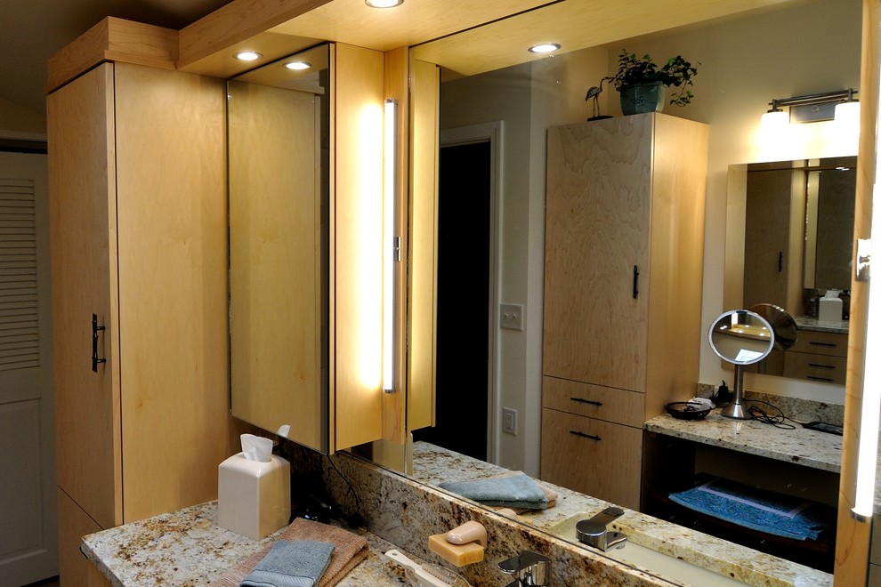 Corner shower - mid-sized contemporary master ceramic tile porcelain tile corner shower idea in Burlington with flat-panel cabinets, light wood cabinets and granite countertops