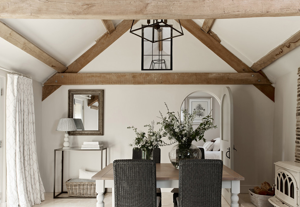 Inspiration for a country separate dining room in Wiltshire with grey walls and a wood stove.
